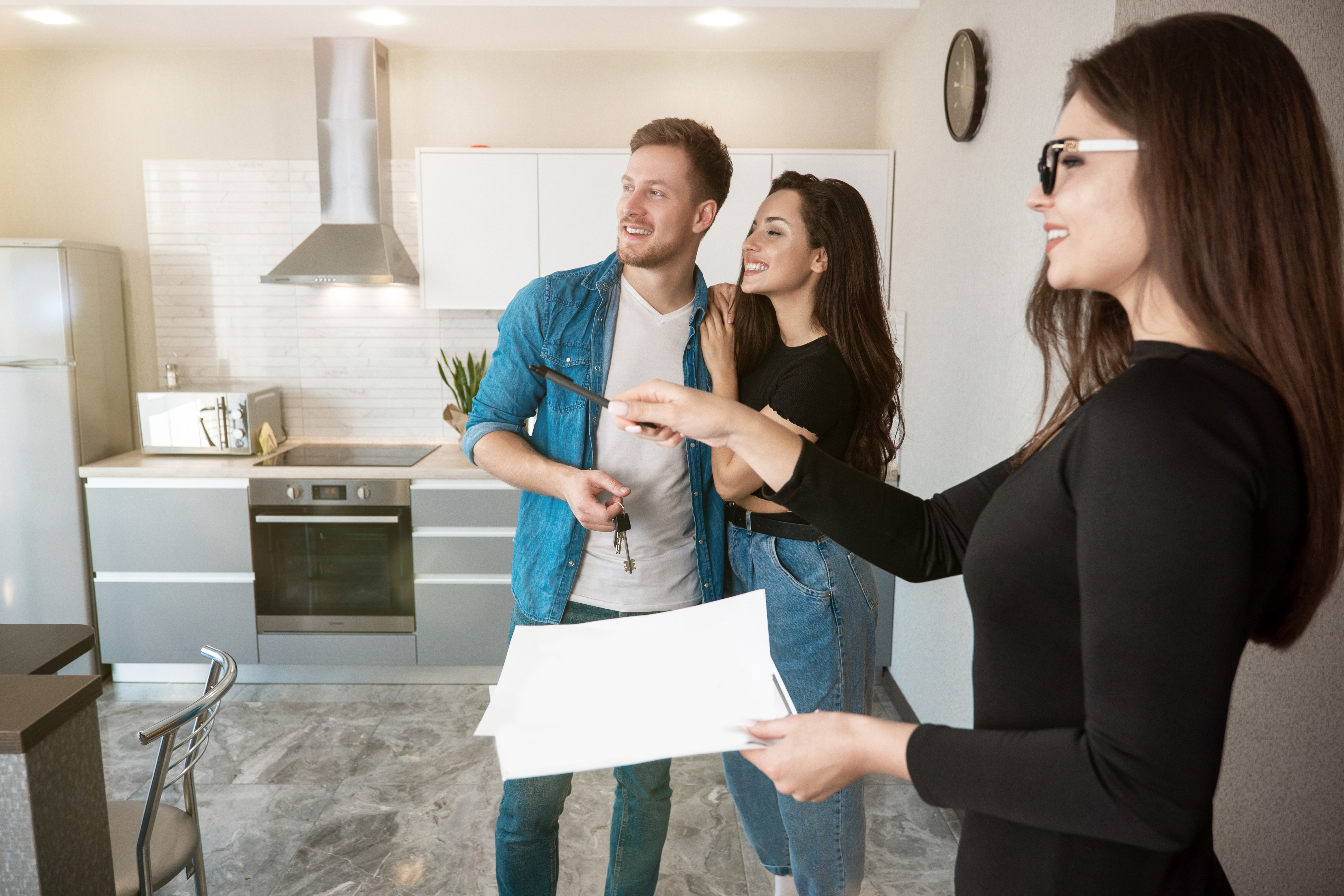 A professional property manager in discussion with a property owner at an office.