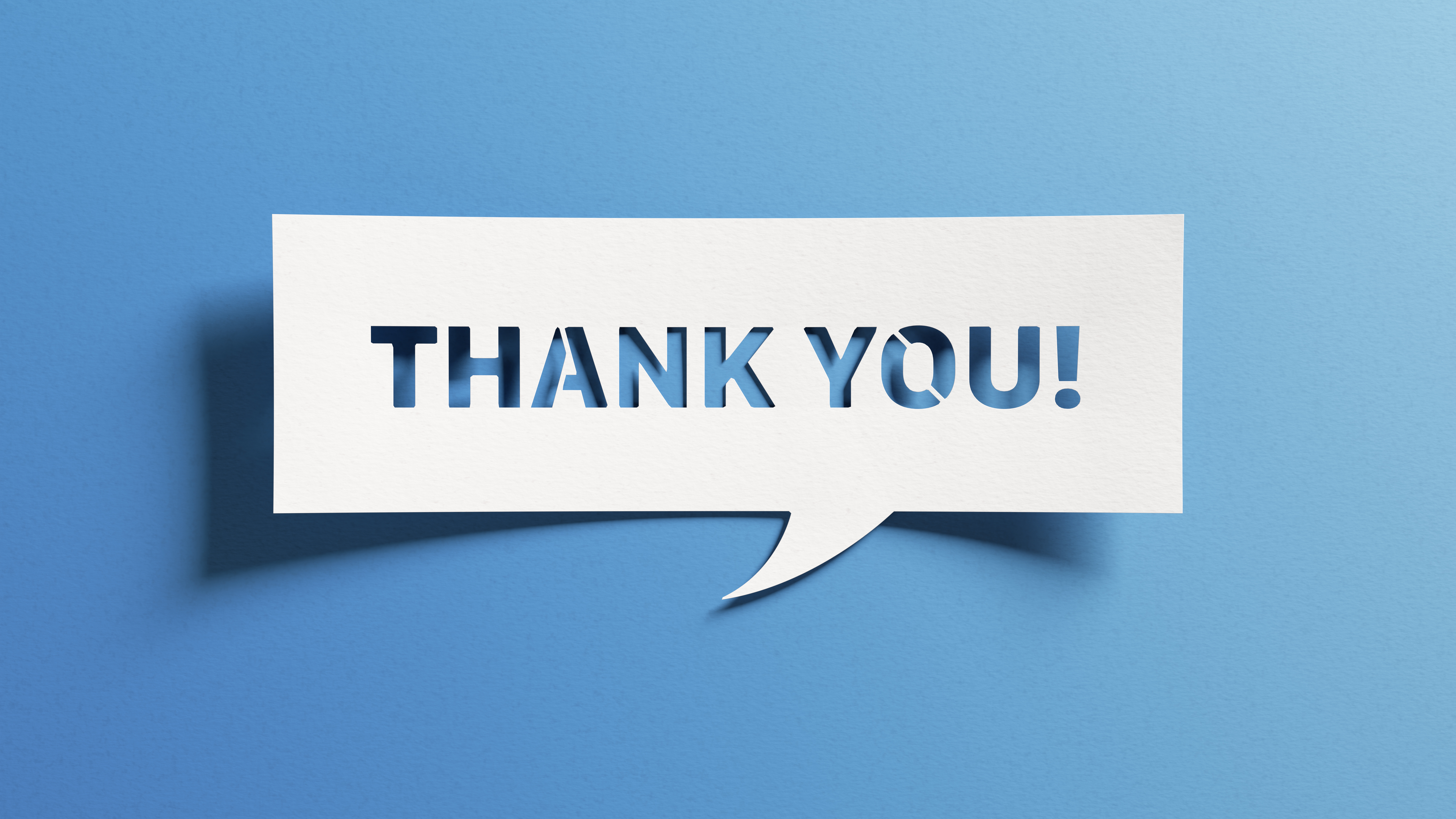 Blue background with a paper-cut style speech bubble containing the words ‘Thank You!’